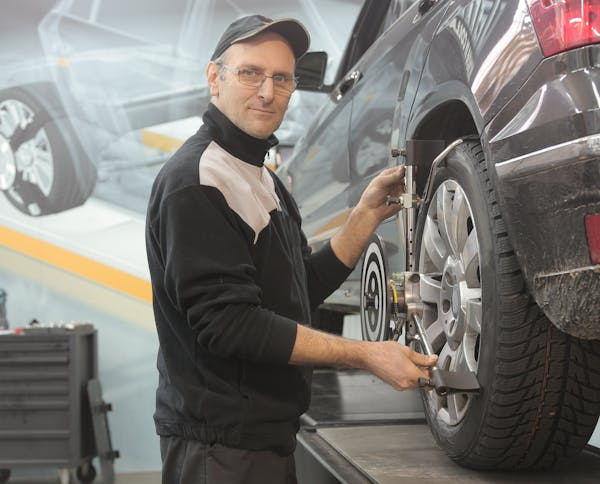  A mechanic inspecting a tire 
