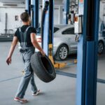 mechanic-holds-tire-repair-garage
